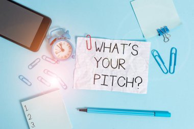 Handwriting text What S Is Your Pitch question. Concept meaning asking about property of sound or music tone Alarm clock clips notepad smartphone rubber band marker colored background.