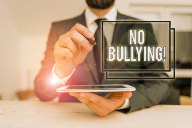 Conceptual hand writing showing No Bullying. Business photo showcasing stop aggressive behavior among children power imbalance Male human wear formal clothes present use hitech smartphone.