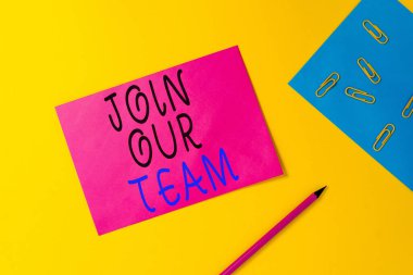 Writing note showing Join Our Team. Business photo showcasing inviting someone into your local group or company Blank paper sheets message pencil clips binder plain colored background.