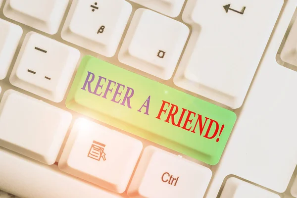 Handwriting text Refer A Friend. Concept meaning direct someone to another or send him something like gift White pc keyboard with empty note paper above white background key copy space. — Stock Photo, Image