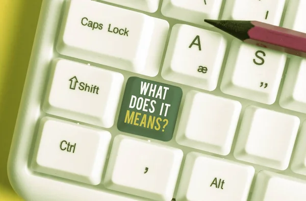 Handwriting text What Does It Means question. Concept meaning asking someone about meaning something said and you do not understand White pc keyboard with empty note paper above white background key c — ストック写真