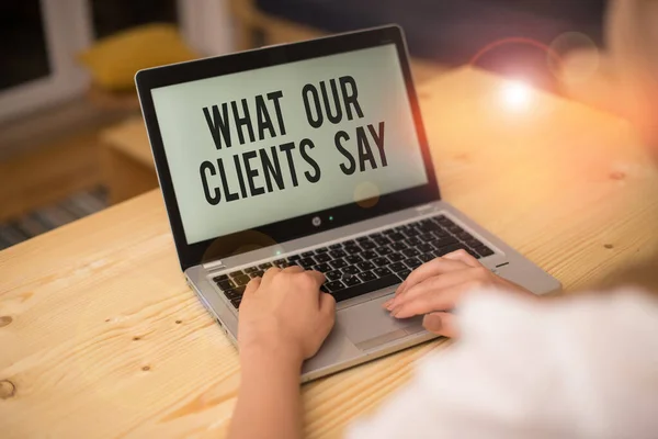 Writing note showing What Our Clients Say. Business photo showcasing testimonials or feedback of aclient about the product woman with laptop smartphone and office supplies technology. — Stok fotoğraf