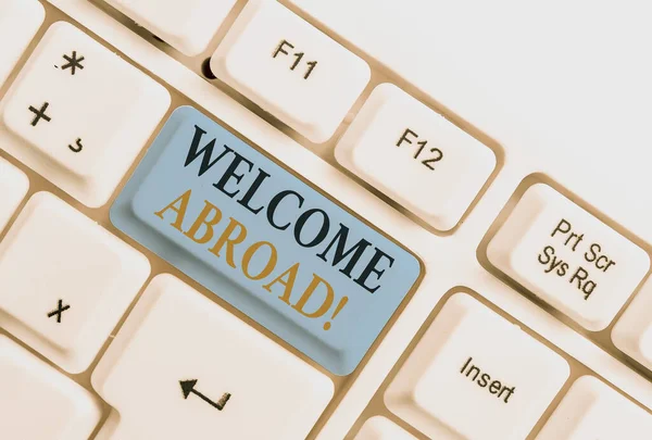 Handwriting text Welcome Abroad. Concept meaning something that you say when someone gets on ship White pc keyboard with empty note paper above white background key copy space. — Stock Photo, Image