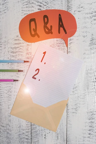 Conceptual hand writing showing Q And A. Business photo text defined as questions being asked and answers Envelope speech bubble ballpoints lying wooden retro background. — 스톡 사진