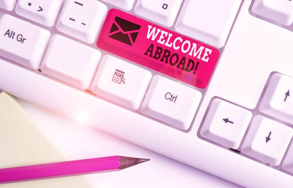 Handwriting text Welcome Abroad. Concept meaning something that you say when someone gets on ship White pc keyboard with empty note paper above white background key copy space. Stock Image