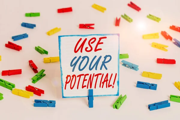 Handwriting text Use Your Potential. Concept meaning achieve as much natural ability makes possible Colored clothespin papers empty reminder white floor background office.