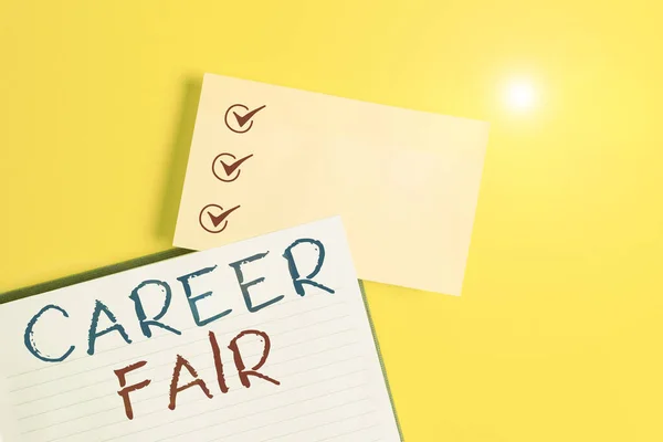 Conceptual hand writing showing Career Fair. Business photo text an event at which job seekers can meet possible employers Empty orange paper with copy space on the yellow table.