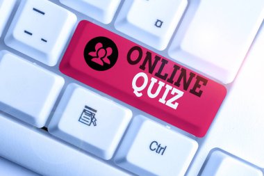 Handwriting text Online Quiz. Concept meaning game or a mind sport that are published on the Internet White pc keyboard with empty note paper above white background key copy space.