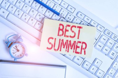 Conceptual hand writing showing Best Summer. Business photo text weather is warmer and analysisy students get a break from school Flat lay above empty note paper on pc keyboard pencils and clock.