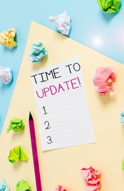 Conceptual hand writing showing Time To Update. Business photo showcasing act updating something someone or updated version program Colored crumpled paper empty reminder blue yellow clothespin.
