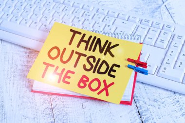 Text sign showing Think Outside The Box. Conceptual photo Be unique different ideas bring brainstorming notebook paper reminder clothespin pinned sheet white keyboard light wooden.