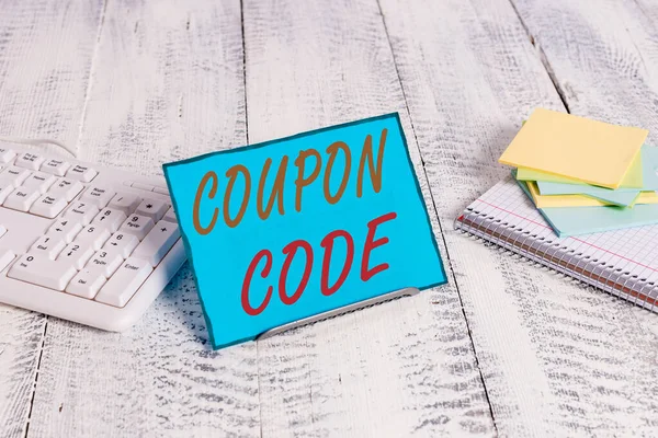 Word writing text Coupon Code. Business concept for ticket or document that can be redeemed for a financial discount Notepaper stand on buffer wire in between computer keyboard and math sheets.
