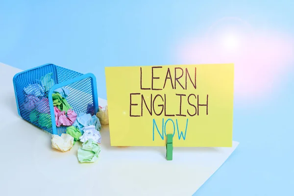 Handwriting text Learn English Now. Concept meaning gain or acquire knowledge and skill of english language Trash bin crumpled paper clothespin empty reminder office supplies tipped.