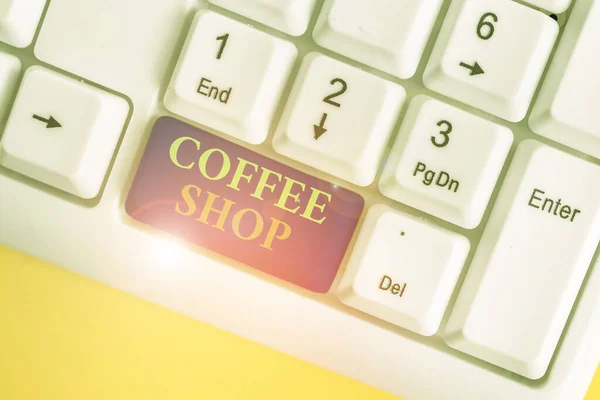 Conceptual hand writing showing Coffee Shop. Business photo showcasing small informal restaurant serving coffee and light refreshments White pc keyboard with note paper above the white background. — Stockfoto