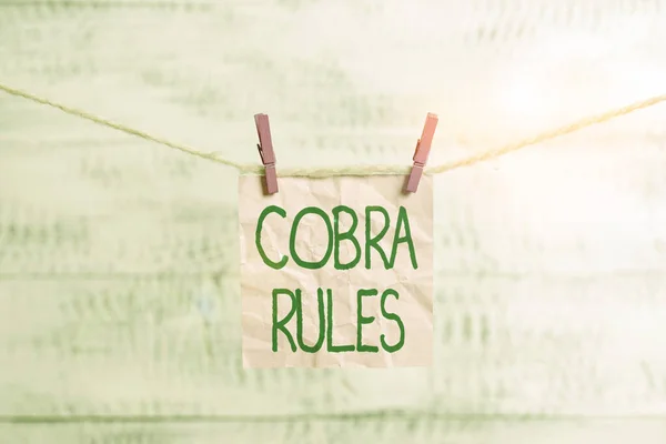 Conceptual hand writing showing Cobra Rules. Business photo showcasing continuing group health insurance coverage after a job loss Clothespin rectangle shaped paper reminder white wood desk. — Stock Photo, Image