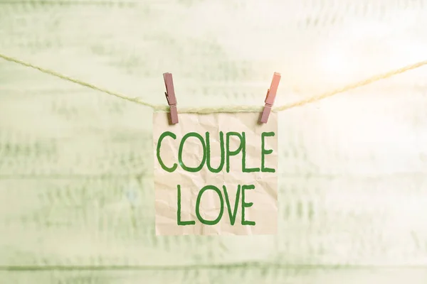 Conceptual hand writing showing Couple Love. Business photo showcasing two showing who love each other very much Feeling pleasure Clothespin rectangle shaped paper reminder white wood desk. — ストック写真