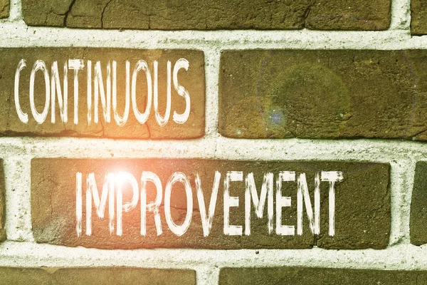 Writing note showing Continuous Improvement. Business photo showcasing ongoing effort to improve products or processes Front view red brick wall facade background Old grunge scenery. — Stockfoto