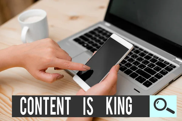 Writing note showing Content Is King. Business photo showcasing believe that content is central to the success of a website woman with laptop smartphone and office supplies technology.