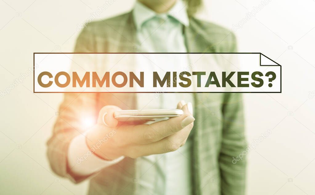 Handwriting text Common Mistakes Question. Concept meaning repeat act or judgement misguided making something wrong Business concept with mobile phone and business woman.