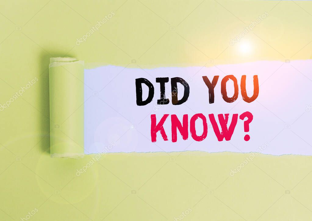 Text sign showing Did You Know Question. Conceptual photo Fun Facts and Figures Information General Knowledge Cardboard which is torn in the middle placed above a plain table backdrop.