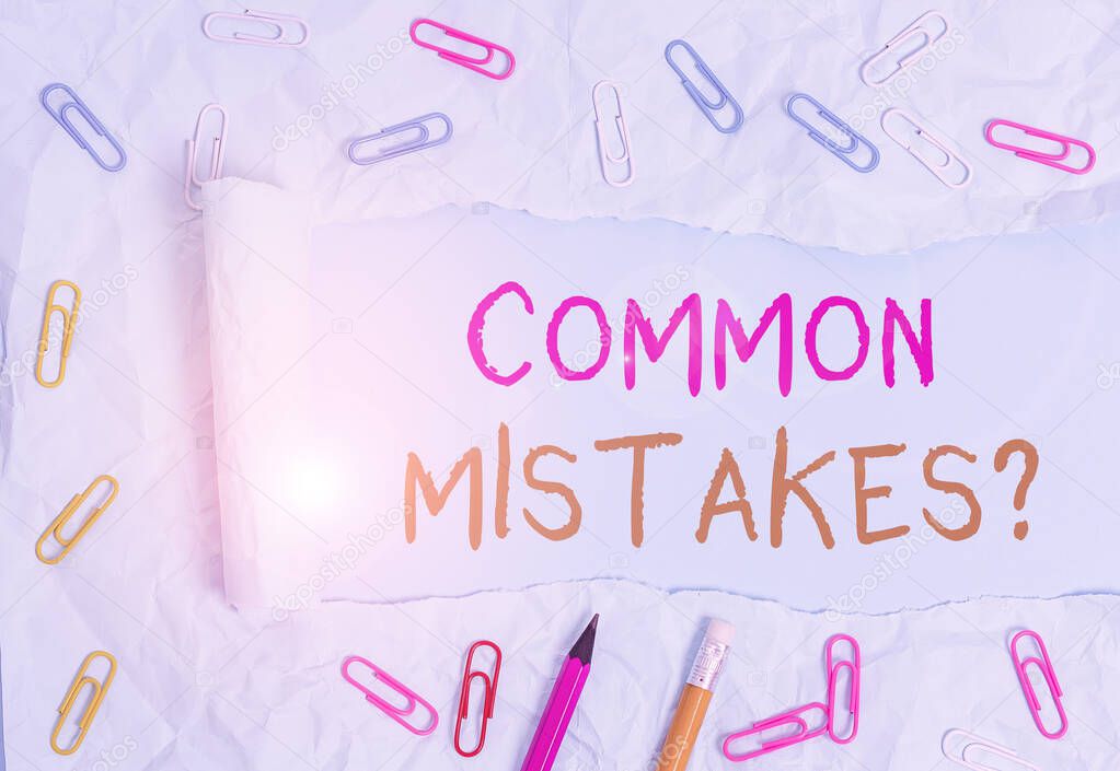 Conceptual hand writing showing Common Mistakes Question. Business photo text repeat act or judgement misguided making something wrong Stationary and torn cardboard on a plain pastel table backdrop.