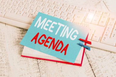 Writing note showing Meeting Agenda. Business photo showcasing items that participants hope to accomplish at a meeting notebook reminder clothespin with pinned sheet light wooden.