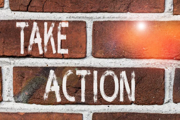 Writing note showing Take Action. Business photo showcasing to do somethingoract in order to get a particular result Front view red brick wall facade background Old grunge scenery.