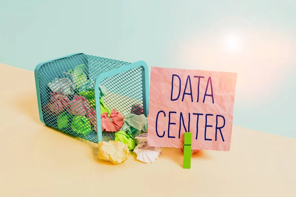 Conceptual hand writing showing Data Center. Business photo text a repository that houses computing facilities like servers Trash bin crumpled paper clothespin reminder office supplies.