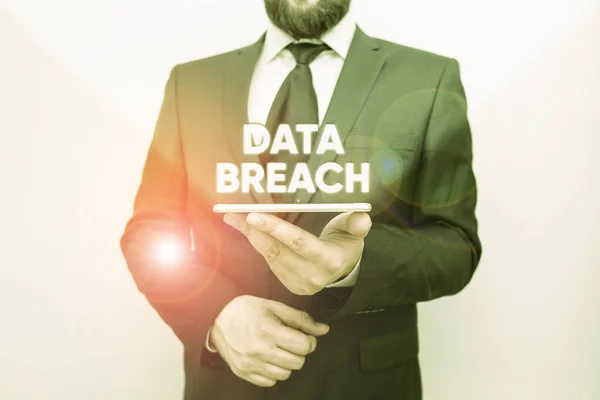 Word writing text Data Breach. Business concept for incident in which sensitive or confidential data is copied Male human wear formal work suit hold smart hi tech smartphone use one hand.