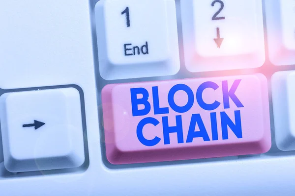 Handwriting text Block Chain. Concept meaning system in which a record of transactions made in bitcoin White pc keyboard with empty note paper above white background key copy space.