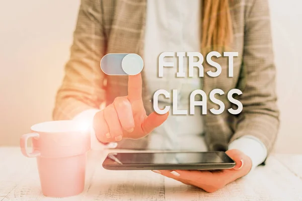 Text sign showing First Class. Conceptual photo the most expensive and most luxurious class of accommodation Business woman sitting with mobile phone and cup of coffee on the table.