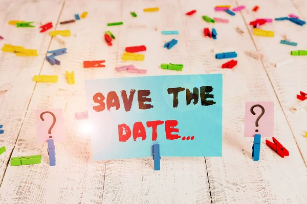 Text sign showing Save The Date. Conceptual photo reserve the mentioned future wedding date on their calendar Scribbled and crumbling sheet with paper clips placed on the wooden table. — Stock Photo, Image