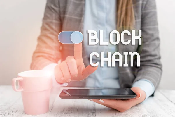 Text sign showing Block Chain. Conceptual photo system in which a record of transactions made in bitcoin Business woman sitting with mobile phone and cup of coffee on the table.