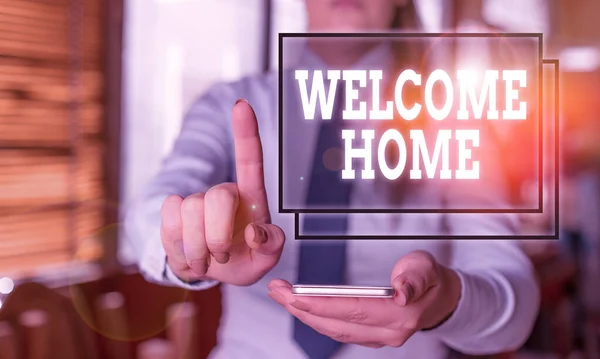 Conceptual hand writing showing Welcome Home. Business photo text a reception usually celebrate the return home of a demonstrating Woman in the background pointing with finger in empty space. — Stockfoto