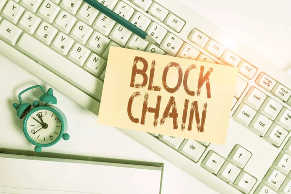 Conceptual hand writing showing Block Chain. Business photo text system in which a record of transactions made in bitcoin Flat lay above empty note paper on pc keyboard pencils and clock. — Stock Photo, Image