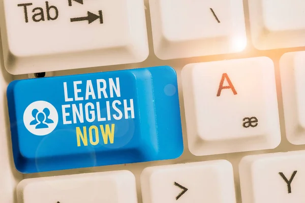 Writing note showing Learn English Now. Business photo showcasing gain or acquire knowledge and skill of english language Keyboard with note paper on white background key copy space.