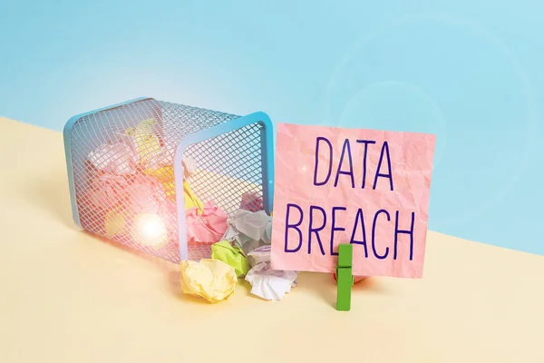 Conceptual hand writing showing Data Breach. Business photo text incident in which sensitive or confidential data is copied Trash bin crumpled paper clothespin reminder office supplies.