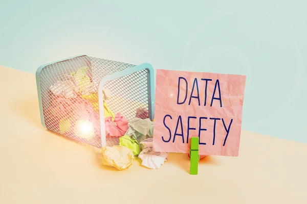 Conceptual hand writing showing Data Safety. Business photo text concerns protecting data against loss by ensuring safe storage Trash bin crumpled paper clothespin reminder office supplies.