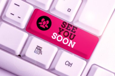 El yazısı. Yakında görüşürüz. Birisine veda etmek ve tekrar buluşmaya gitmek için kullanılan kavram Beyaz pc klavye üzerinde boş not kağıdı beyaz arkaplan anahtar alanı üzerinde.