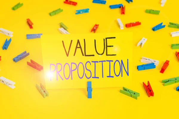 Text sign showing Value Proposition. Conceptual photo feature intended to make a company or product attractive Colored clothespin papers empty reminder yellow floor background office.