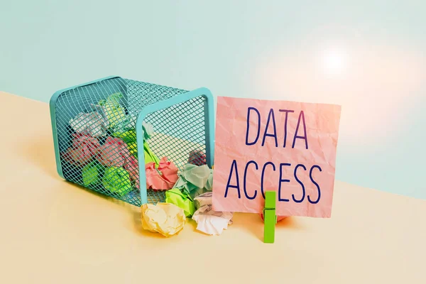Conceptual hand writing showing Data Access. Business photo text a user s is ability to access data stored within a database Trash bin crumpled paper clothespin reminder office supplies.
