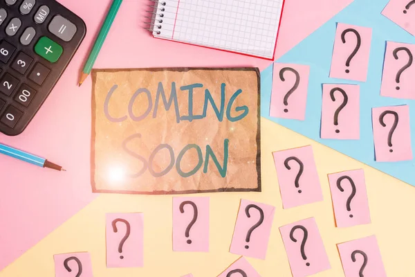 Writing note showing Coming Soon. Business photo showcasing something is going to happen soon or after a short time Mathematics stuff and writing equipment above pastel colours background.