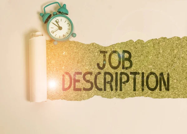 Text sign showing Job Description. Conceptual photo a formal account of an employee s is responsibilities Alarm clock and torn cardboard placed above a wooden classic table backdrop.