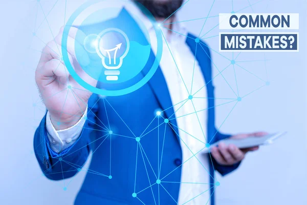 Handwriting text writing Common Mistakes Question. Concept meaning repeat act or judgement misguided making something wrong Male human wear formal work suit presenting presentation using smart device. — Stock Photo, Image