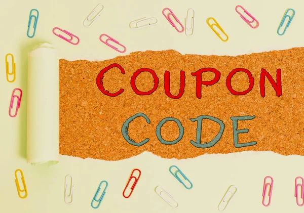 Handwriting text Coupon Code. Concept meaning ticket or document that can be redeemed for a financial discount Paper clip and torn cardboard placed above a wooden classic table backdrop. — Stock Photo, Image