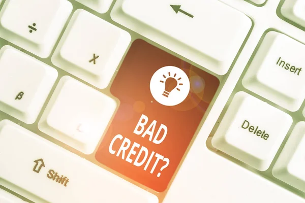 Conceptual hand writing showing Bad Creditquestion. Business photo text inabilityof a demonstrating to repay a debt on time and in full White pc keyboard with note paper above the white background. — Stock Photo, Image