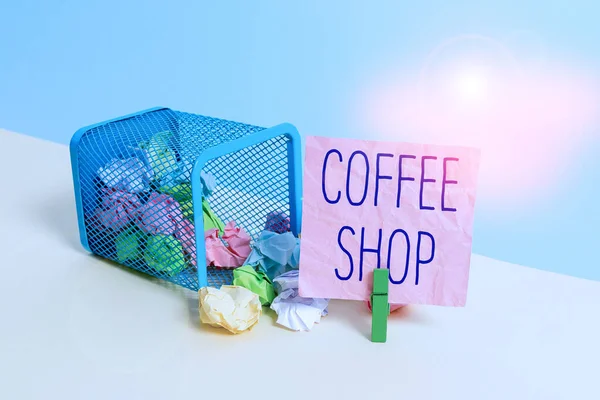 Conceptual hand writing showing Coffee Shop. Business photo text small informal restaurant serving coffee and light refreshments Trash bin crumpled paper clothespin reminder office supplies.