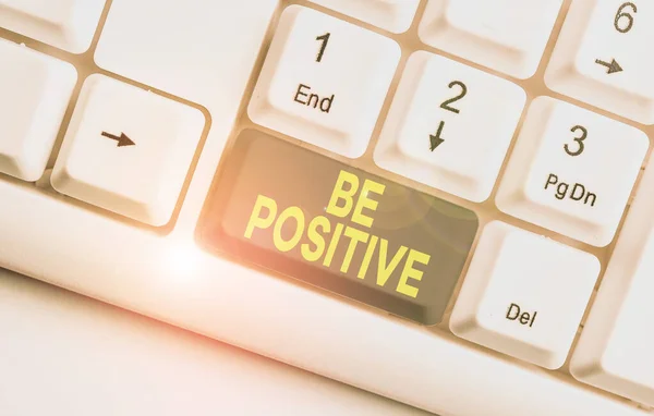 Writing note showing Be Positive. Business photo showcasing giving cause for hope and confidence Without any doubt White pc keyboard with note paper above the white background.