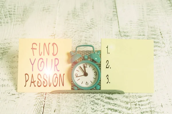Writing note showing Find Your Passion. Business photo showcasing Seek Dreams Find best job or activity do what you love Mini blue alarm clock standing above buffer wire between two paper.