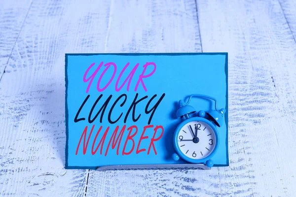 Conceptual hand writing showing Your Lucky Number. Business photo showcasing believing in letter Fortune Increase Chance Casino Alarm clock tilted above buffer wire in front of notepaper.